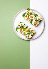 Bruschetta with spinach, honey, blue cheese, pear, and nuts. Healthy eating. Vegetarian food.