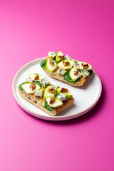 Bruschetta with spinach, honey, blue cheese, pear, and nuts. Healthy eating. Vegetarian food.