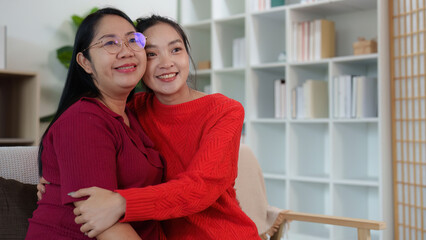 Affectionate Moment. Two women hugging and smiling together indoors.