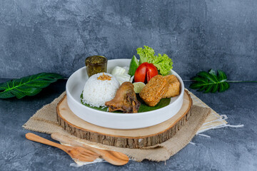 Duck chilli green, or bebek cabe hijau, is a flavorful Indonesian dish featuring tender duck simmered and stir-fried with a vibrant green chili sauce, shallots, garlic, and spices—served with rice, te