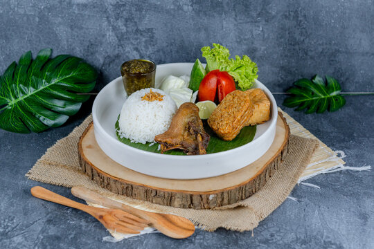 Duck chilli green, or bebek cabe hijau, is a flavorful Indonesian dish featuring tender duck simmered and stir-fried with a vibrant green chili sauce, shallots, garlic, and spices&mdash;served with rice, te