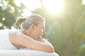 Woman, rest and sleep at spa outdoor for sunlight therapy, fresh air and pamper session. Female...