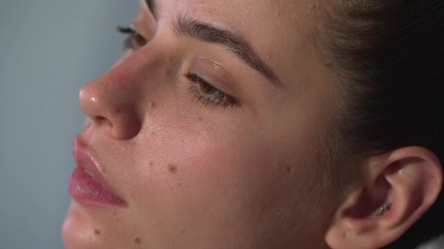 Skin care. Fashion make-up fot young sexy woman. Close up visage, cosmetic, mascara. Makeup artist applying foundation skin, blusher and powder. Beautiful woman face.