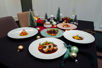 Festive Christmas dining table featuring a variety of culinary delights. The table is adorned with decorations and seasonal food
