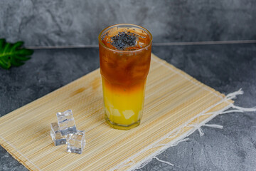 Orange tea is a refreshing blend of black tea and citrusy orange juice, sometimes with jelly cubes and basil seeds for extra texture. This vibrant drink offers a tangy, sweet, and cooling sensation.
