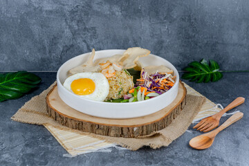 Seafood fried rice features savory stir-fried rice with fresh shrimp, squid, and veggies, topped with a sunny-side-up egg and crackers. Vibrant, flavorful, and satisfying for any meal.