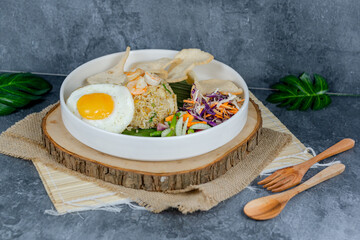 Seafood fried rice features savory stir-fried rice with fresh shrimp, squid, and veggies, topped with a sunny-side-up egg and crackers. Vibrant, flavorful, and satisfying for any meal.