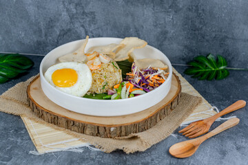 Seafood fried rice features savory stir-fried rice with fresh shrimp, squid, and veggies, topped with a sunny-side-up egg and crackers. Vibrant, flavorful, and satisfying for any meal.