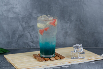 Refreshing fruit punch with vibrant blue hues, sparkling soda, and mixed fruit cubes. Served chilled, this drink blends tropical flair and fruity sweetness for any occasion.