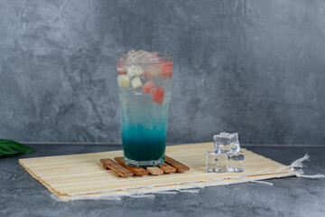 Refreshing fruit punch with vibrant blue hues, sparkling soda, and mixed fruit cubes. Served chilled, this drink blends tropical flair and fruity sweetness for any occasion.