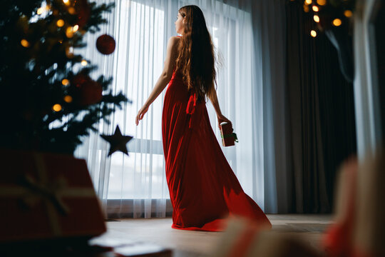 woman near Christmas tree indoor