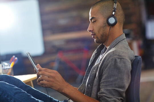 Headphones, playing and tablet with game developer in office for software update or testing. App, design and streaming with engineer man in creative workplace for gaming graphics or video calibration