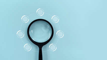 Magnifying Glass Examining a Segmented Diagram on Blue Background. infographic 7 circle diagram chart process