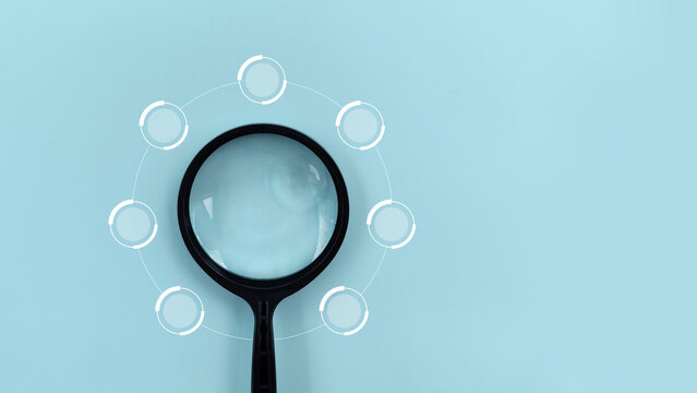 Magnifying Glass Examining a Segmented Diagram on Blue Background. infographic 7 circle diagram chart process