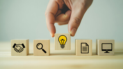 Innovative business solutions concept: hand placing light bulb block among search, deal, document, and technology icons for creative problem solving