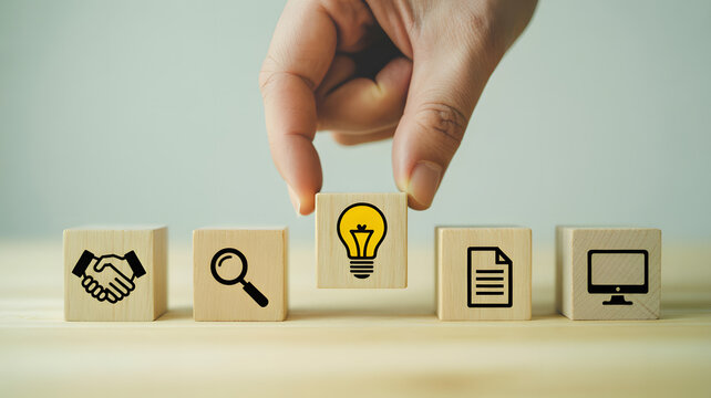 Innovative business solutions concept: hand placing light bulb block among search, deal, document, and technology icons for creative problem solving