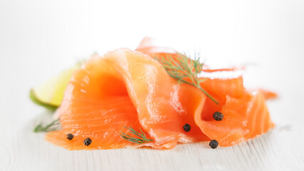 fresh smoked salmon slice with black pepper, dill and lemon