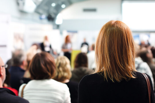 Engaged audience listening to a speaker at a business conference, learning new strategies for success and professional development in a collaborative environment