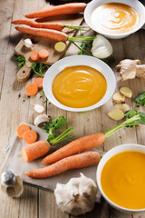 vegetable soup in bowl with ingredients on wooden board