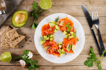 smoked salmon, avocado and fresh aromatics herbs.Holiday dining salad plate