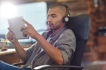 Design, headphones and tablet with game developer in office for software update or testing. App, playing and streaming with designer man in creative workplace for graphics or video calibration