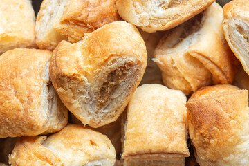 close-up of party cocktail sausage rolls in a pile background backdrop. Party catering food concept.