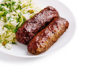 Delicious grilled kebabs served with fresh cabbage salad on a white plate