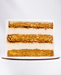 Delicious layered cake with creamy frosting displayed on a wooden board
