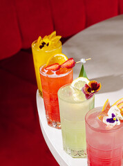Colorful cocktails on a table in a vibrant bar during a lively evening