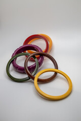Fototapeta premium Close up studio shot of various color vintage bakelite bangle bracelets on white background, with copy space