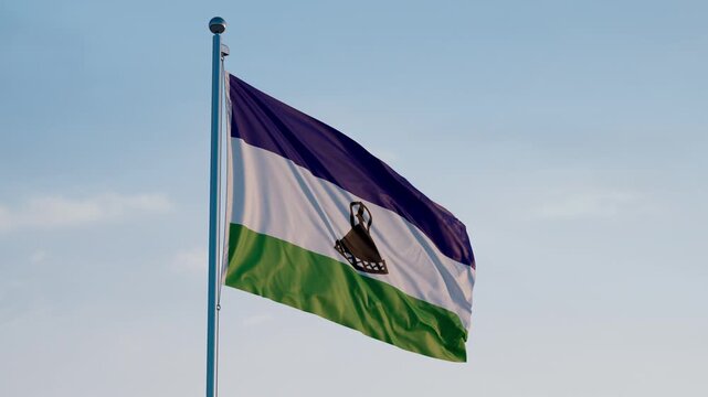 Lesotho, Maseru: Cinematic Waving National Flag Against Blue Sky