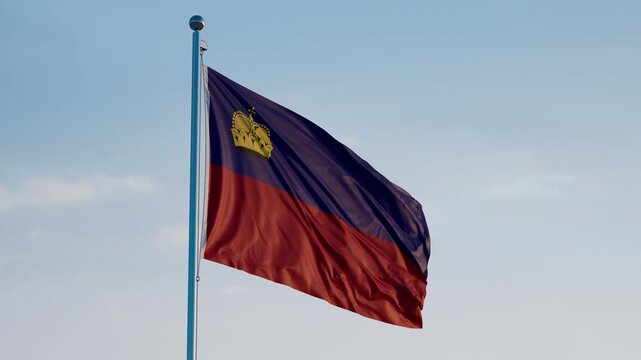 Liechtenstein, Vaduz: Cinematic Waving National Flag Against Blue Sky