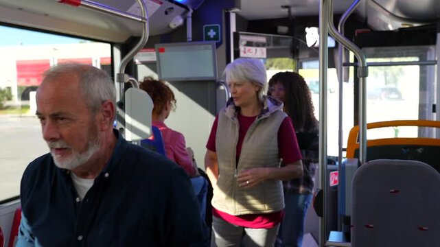 People boarding a public bus validating tickets