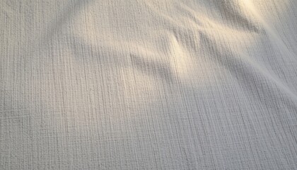 Fototapeta premium warm cotton grey 45: a linen ash tone tone with subtle woven fabric grain, lit by gentle golden hour glow, accented with tiny fiber speckles. composition: soft gradient center