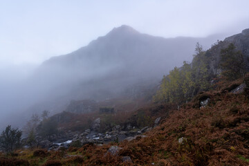 Mist rolling over a mountain slope at dawn in Snowdonia