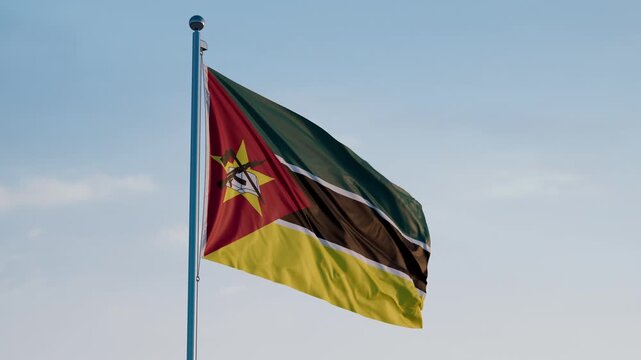 Mozambique, Maputo: Cinematic Waving National Flag Against Blue Sky