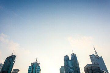 Modern city skyline with tall buildings under blue sky