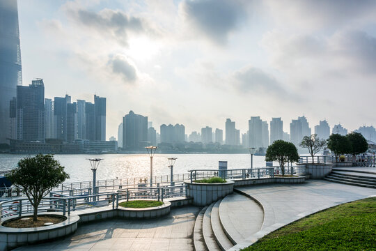 Scenic waterfront with modern skyscrapers under cloudy sky
