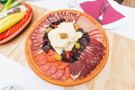 Traditional Balkan charcuterie platter with assorted cured meats and creamy cheese