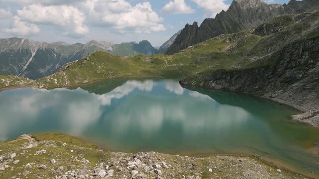 Peaceful mountain lake at Gramais, clear skies, serene landscape view
