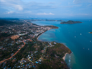 Obraz premium Panoramic aerial view of Southern Phuket Island and Promthep Cape at blue hour, showing coastline and urban development against the Andaman Sea.