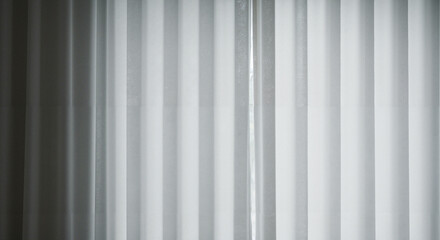 Obraz premium Sheer white curtains gently hanging indoors in natural light 
