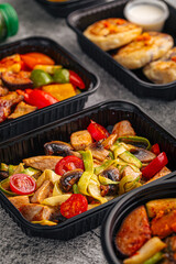 Colorful chicken stir fry prepared with mushrooms tomatoes peppers and zucchini served in container
