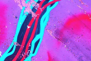Vibrant paint splatter in neon blue, red, purple. 80s graffiti aesthetic, bold colors, abstract texture. Modern 90s, Y2K style, digital art, creative banner, urban visuals.