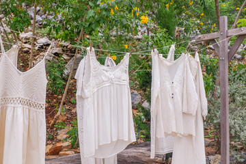 Different clothes drying on laundry line against garden background,clothes hanging laundry on washing line for drying towels drying on the clothesline.