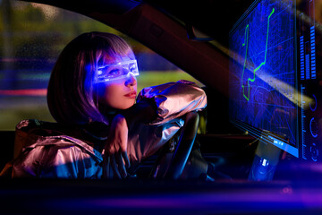 young woman driving car at night wearing futuristic AR glasses