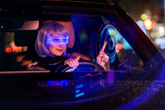 Woman in futuristic glasses driving car touching virtual display.