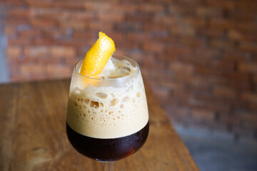 Espresso coffee with orange juice on table and brick background,cafe house,travel morning coffee.