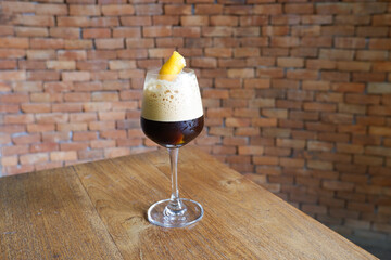 Espresso coffee with orange juice on table and brick background,cafe house,travel morning coffee.