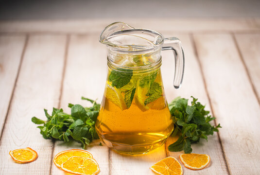 Cold refreshing citrus drink with fresh mint leaves ice cubes and sweet aroma served in pitcher